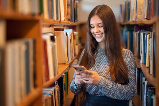 Portrait of a student girl using phone