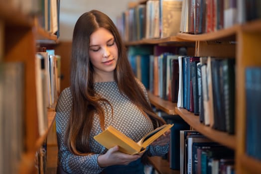 Student getting ready for project, looking for information in local library, reading books