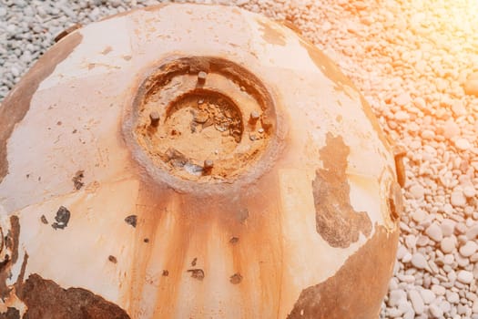 Old rusty sea mine on the beach.