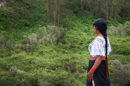 copyspace of an indigenous woman in her traditional dress of her culture observing the beauty of mother nature's landscape. earth day. High quality photo