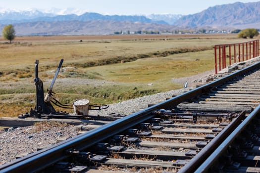 manual railroad switch with lever and counterweight at summer day.