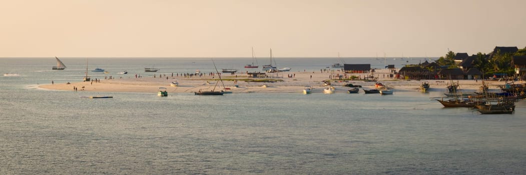 Zanzibar beach where tourists and locals mix together of colors and joy, concept of summer vacation, aerial view of Kendwa beach, Tanzania