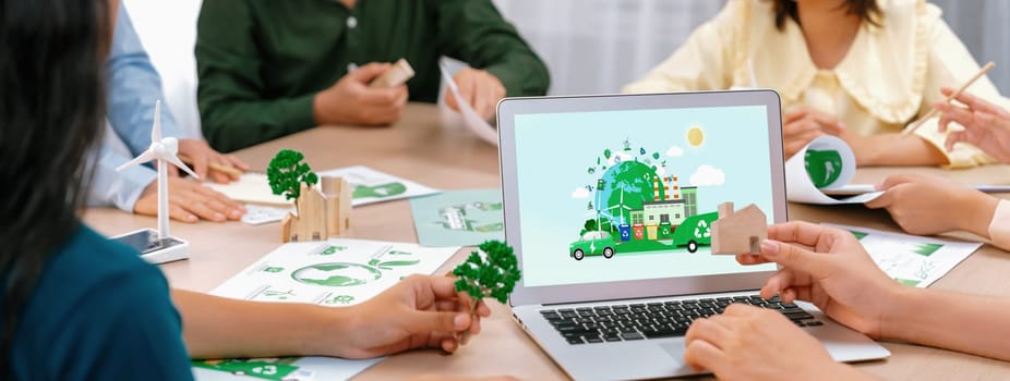 Green city and waste management illustrate displayed on laptop. Business team presenting green design to customer. ESG environment social governance and Eco conservative concept. Closeup. Delineation.