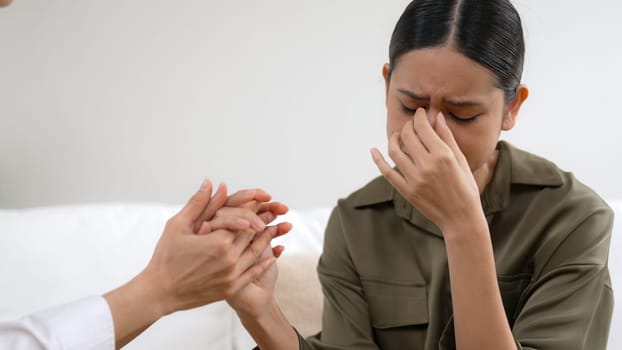 Supportive and comforting hands cheering up depressed patient person or stressed mind with empathy. Psychologist reassuring stressful and sad patient in vivancy clinic.