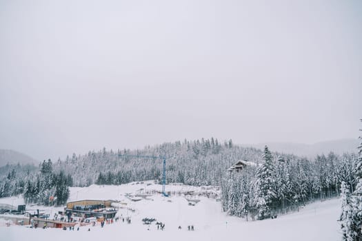 Skiers ride along the slope of the Kolasin 1600 ski resort. Montenegro. High quality photo