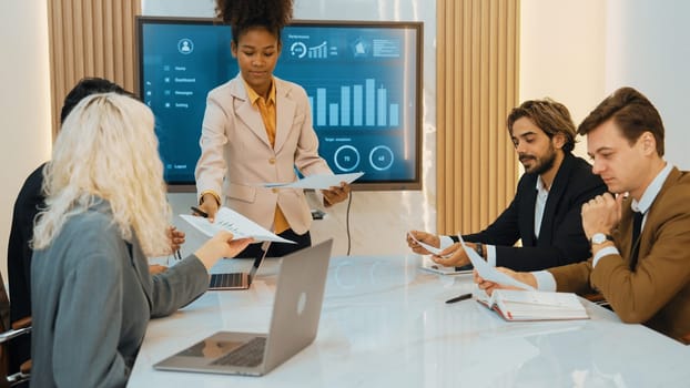 Presentation in office or ornament meeting room with analyst team utilize BI Fintech to analyze financial data. Businesspeople analyzing BI dashboard power display on TV screen for strategic planning
