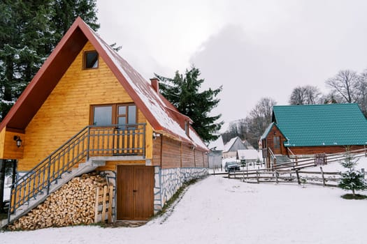 Wooden cottages in a small village in a snowy forest. High quality photo