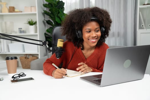 Host channel of beautiful African woman talking in online broadcast teaching marketing influencer, with listeners in broadcast or online. Concept of anywhere at work place. Tastemaker.