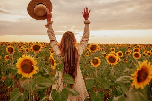 Woman in the sunflowers field. Summer time. Young beautiful woman standing in sunflower field.