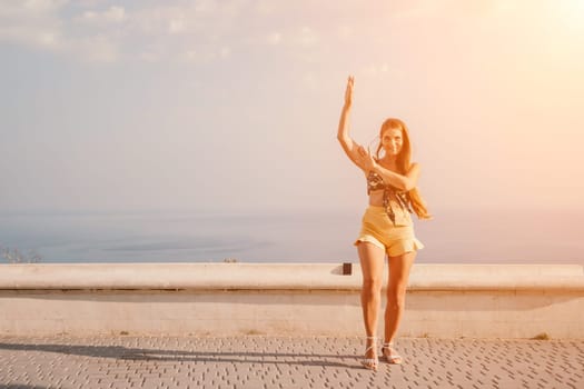 silhouette of a happy woman who dances, spins and raises her hands to the sky. A woman is enjoying a beautiful summer day.