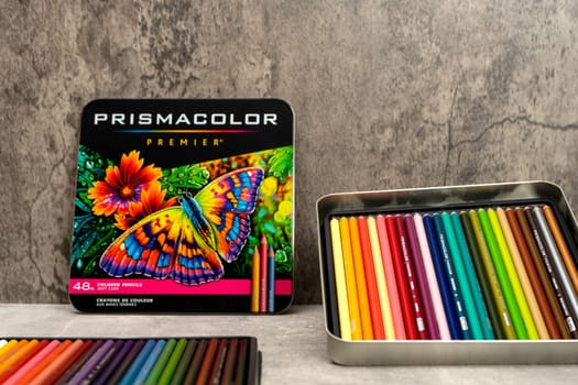 Burriana, Spain 12-30-2023: Product image of a metal box of colored pencils from the Prismacolor brand on a gray background.
