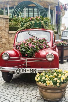 Vintage car decorated with flowers in the photo zone in a romantic style. High quality photo