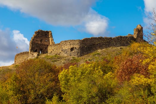 view of a ruined fortress in Ossetia, towering on a hill of a mountain