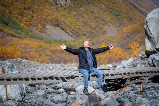 A moment of solitude: a man contemplates the majesty of the mountains surrounded by nature