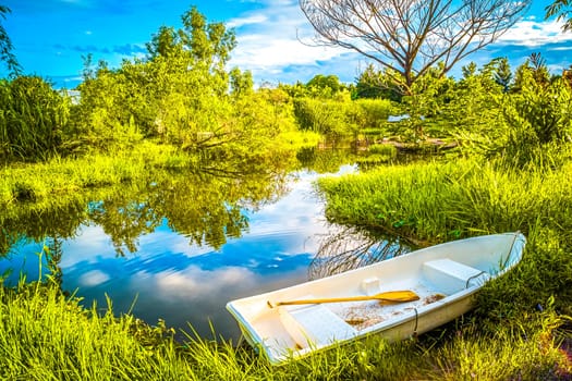 The beautiful landscape ofmall wooden rowing boat on a calm lake.