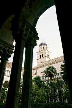 View through the arch to the Franciscan monastery in the garden. Dubrovnik, Croatia. High quality photo