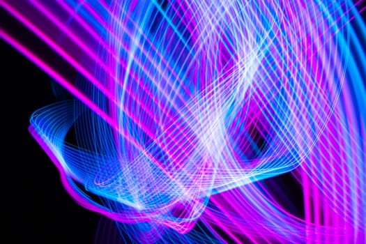 Abstract technology background of long exposure light. Blue and pink on black. High quality photo