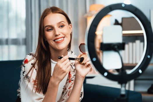 Woman influencer shoot live streaming vlog video review makeup utmost social media or blog. Happy young girl with cosmetics studio lighting for marketing recording session broadcasting online.