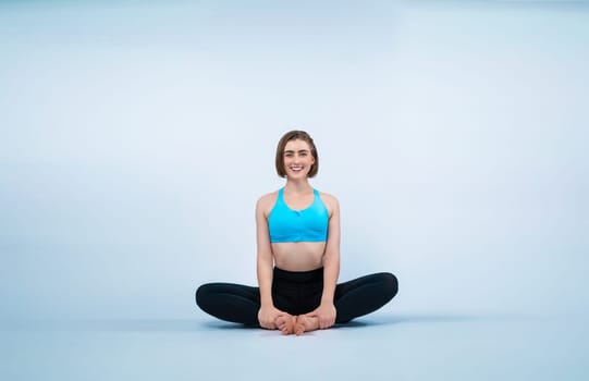 Full body length gaiety shot athletic and sporty woman doing healthy and meditative yoga exercise workout posture on isolated background. Healthy active and body care lifestyle