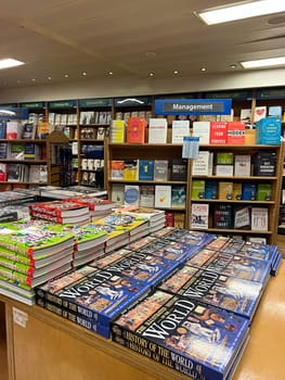 Books on world history and science lie on the table in the store. High quality photo