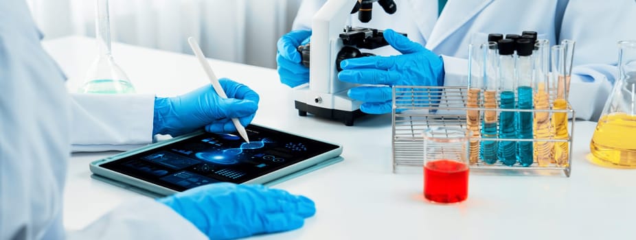 Laboratory research team advance healthcare with scientific expertise, laboratory equipment, and innovative medical biotechnology software, researching new medicines and developing cure.Panorama Rigid