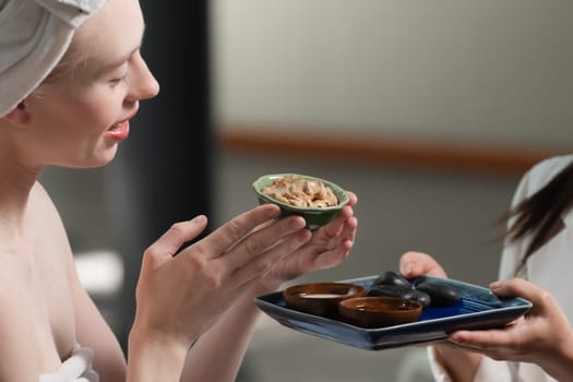 Portrait of two attractive caucasian woman in white towel with beautiful skin hold the tray contained ingredients of homemade herbal facial mask. Healthy and peaceful concept. Closeup Tranquility.