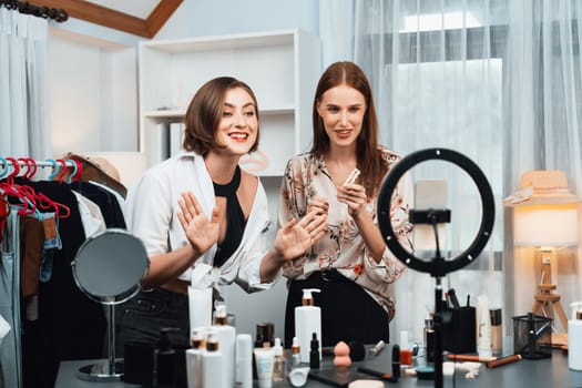 Woman influencer shoot live streaming vlog video review makeup utmost social media or blog. Happy young girl with cosmetics studio lighting for marketing recording session broadcasting online.