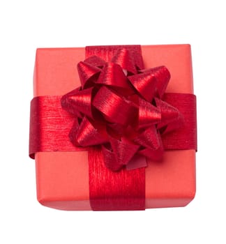 Box is wrapped in red gift wrapping and red ribbon on a white isolated background, top view