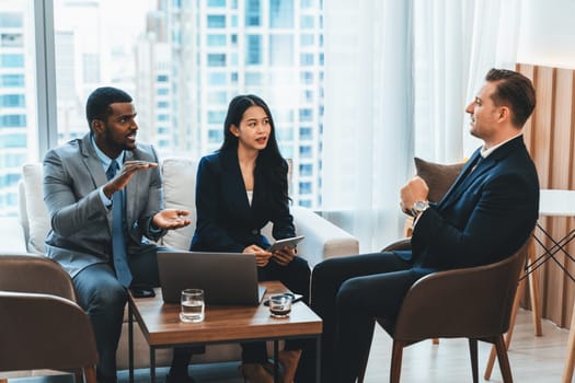 African businessman present start up project to expert investor. Group of multicultural business team solving problems, discussing business idea with skyscraper at modern business lounge. Ornamented