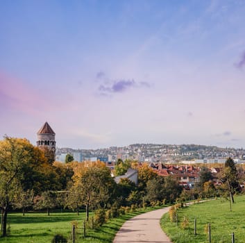 Germany, Stuttgart panorama view. Beautiful houses in autumn, Sky and nature landscape. Vineyards in Stuttgart - colorful wine growing region in the south of Germany with view over Neckar Valley. Germany, Stuttgart city panorama view above vineyards, industry, houses, streets, stadium and highway at sunset in warm orange light.