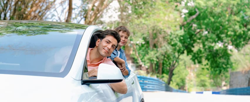 Dad and son on the road trip by the green nature countryside, family vholiday vacation concept. Young little boy enjoying family car adventure vacation with his father. Perpetual