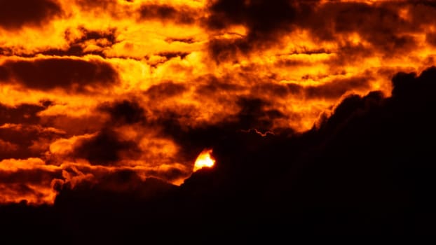 Time lapse of the beautiful sky with clouds at sunset. Sunset sky at dusk in the evening with natural sky background with golden orange clouds.