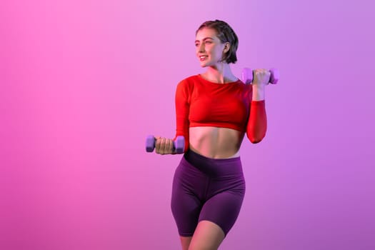 Full body length gaiety shot athletic and sporty woman with dumbbell for weight lifting as bodybuilding exercise in standing posture on isolated background. Healthy active and body care lifestyle