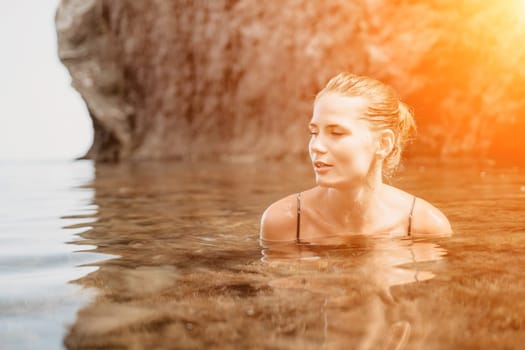 Woman travel sea. Happy tourist taking picture outdoors for memories. Woman traveler looks at the edge of the cliff on the sea bay of mountains, sharing travel adventure journey.