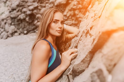 Woman travel sea. Young Happy woman in a long red dress posing on a beach near the sea on background of volcanic rocks, like in Iceland, sharing travel adventure journey