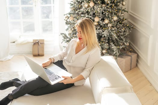 young woman with a notebook near Christmas tree. High quality photo