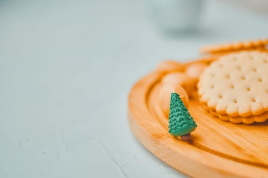 Mini Christmas tree with cookies on white table