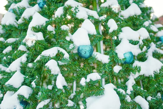 Decorated Christmas tree. Close-up of blue balls hanging from a decorated Christmas tree.