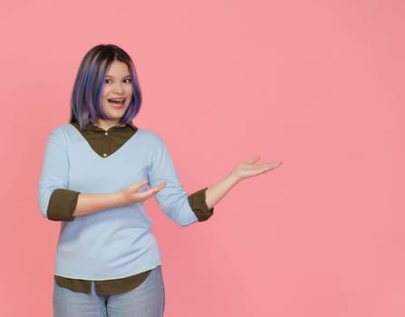 Teenager Girl Extends Friendly Welcome With Smile, Showcasing Empty Copy Space With Hands On Pink Background. Essence Of Friendly And Approachable Teenager Extending Warm Welcome To Viewer. High quality photo