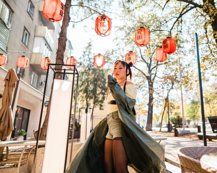 Portrait of an Asian woman against the background of Chinese lanterns outdoors