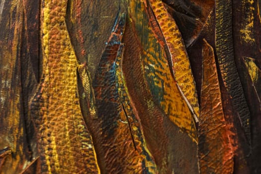 Pieces of leather painted with brown, yellow and orange paint. Texture and backgrounds.