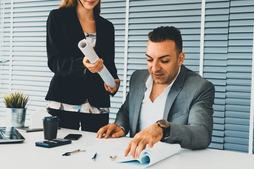 Businessman executive checking work while meeting discussion with businesswoman worker in modern workplace office. People corporate business team concept. uds