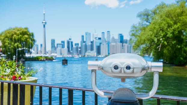 Panoramic view of Toronto skyline, Lake Ontario with binocular from island on a sunny day, Toronto, Ontario, Canada