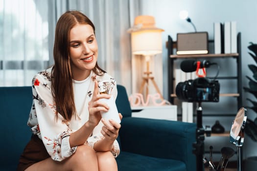 Woman influencer shoot live streaming vlog video review makeup utmost social media or blog. Happy young girl with cosmetics studio lighting for marketing recording session broadcasting online.