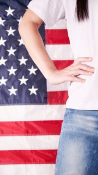 Close up of woman body and hand against american flag at 4th july. Faceless. Independence day, celebration, patriotism and holidays concept