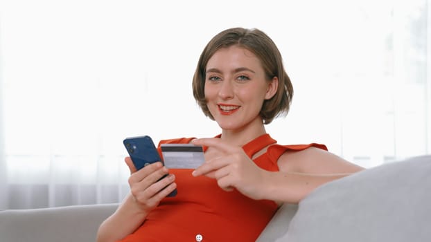 Woman shopping or pay online on internet marketplace browsing for sale items for modern lifestyle and use credit card for online payment from wallet protected by prim cyber security software