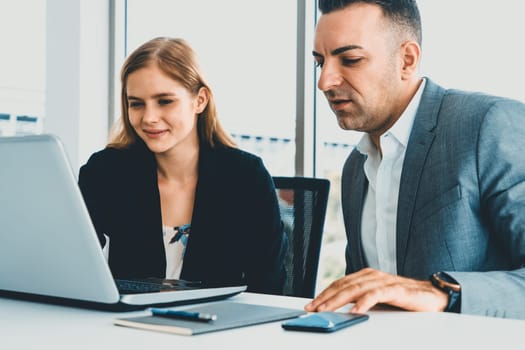 Businessman executive is in meeting discussion with a businesswoman worker in modern workplace office. People corporate business team concept. uds