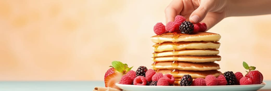Stack of pancakes with berries. Advertising banner, web banner. Lush delicious pancakes with blueberries, raspberries and syrup for homemade breakfast. Lifestyle concept of food, cooking. Copy space