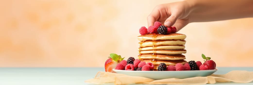Stack of pancakes with berries. Advertising banner, web banner. Lush delicious pancakes with blueberries, raspberries and syrup for homemade breakfast. Lifestyle concept of food, cooking. Copy space
