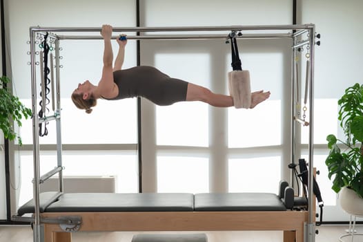 Pregnant woman doing pilates on a reformer